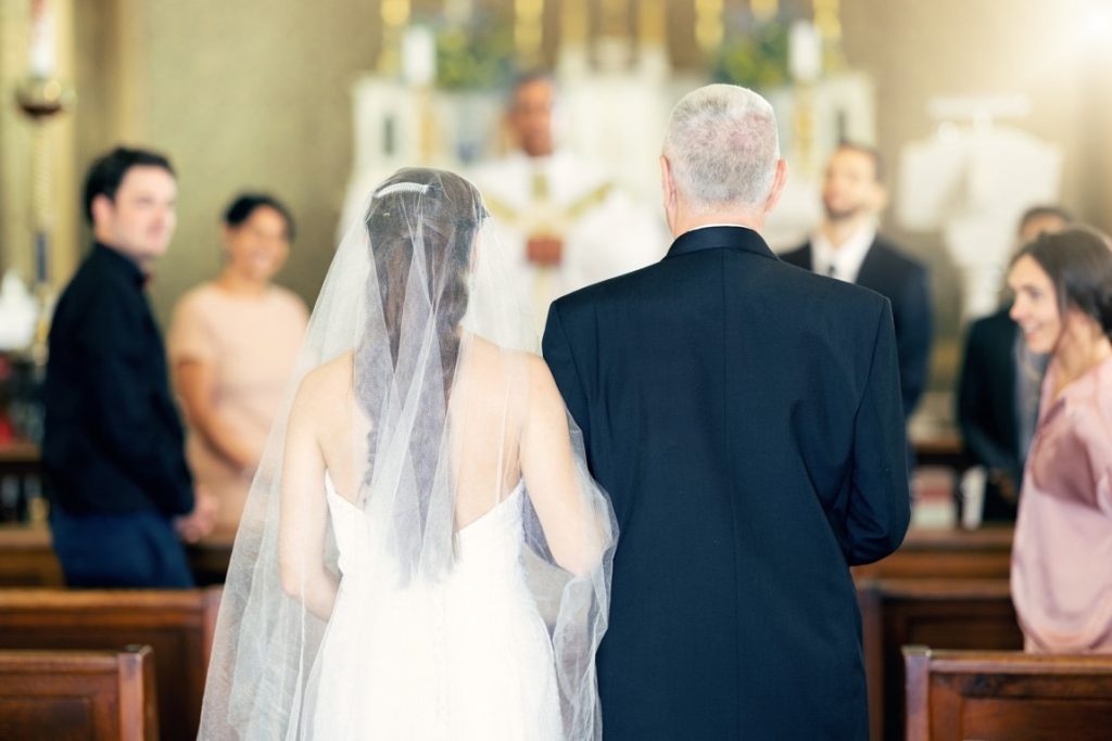 Bride and her father walking down the aisle during a wedding ceremony