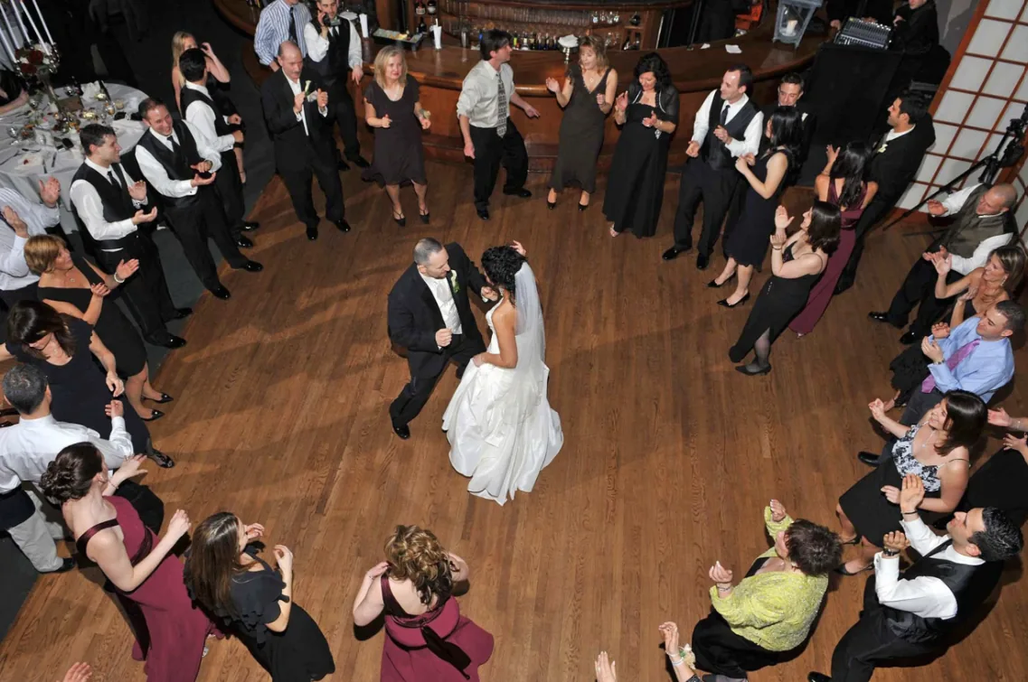 Bride, groom and guests dancing at a wedding reception